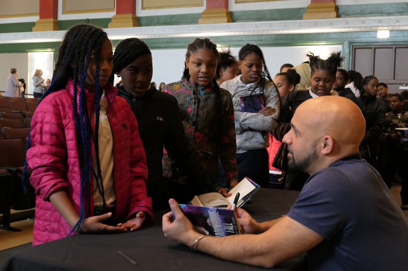 Author Daniel Jose Older signs books for students